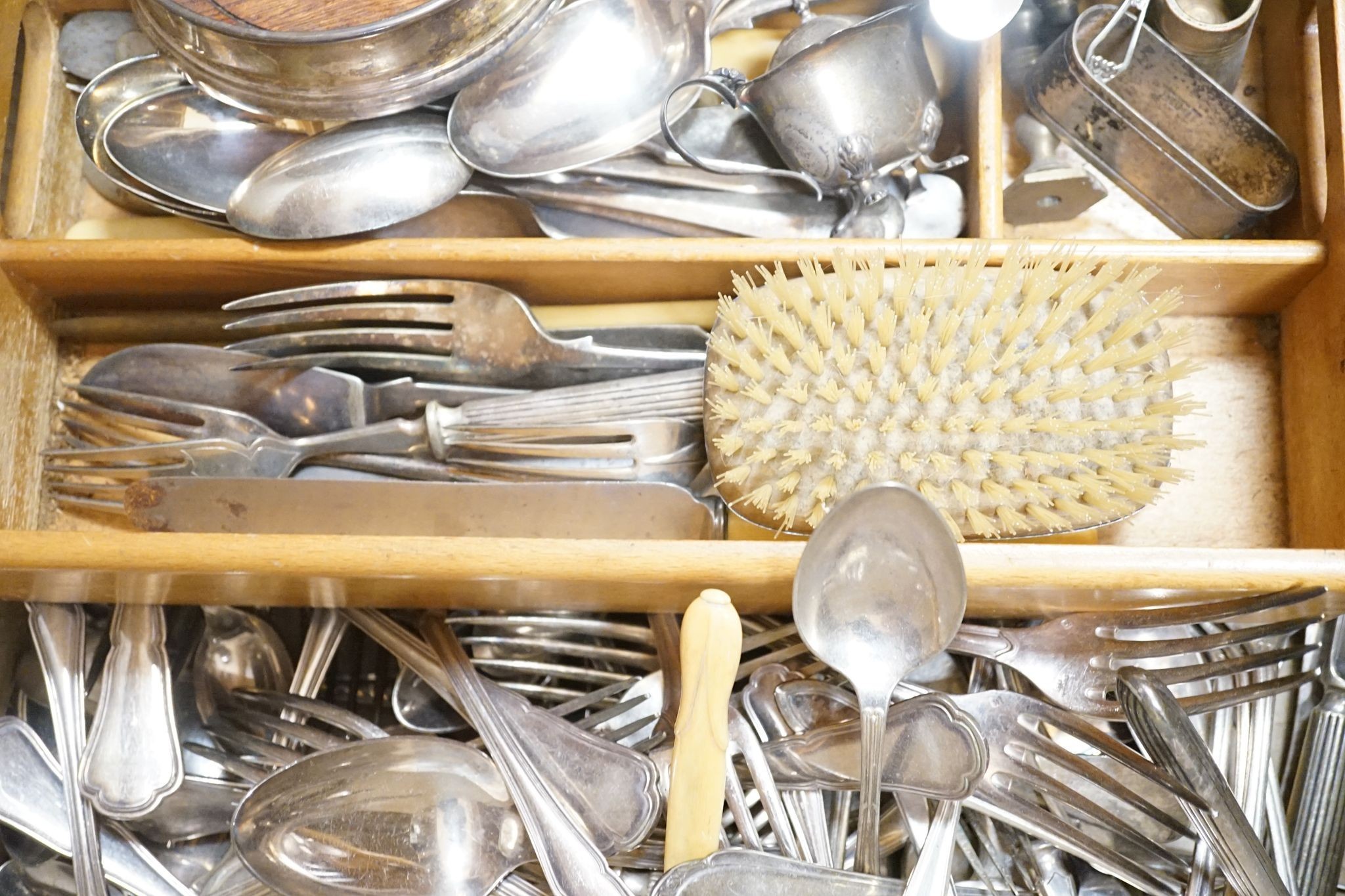 Small silver cutlery, together with a silver presentation coaster, a silver backed brush and various plated wares